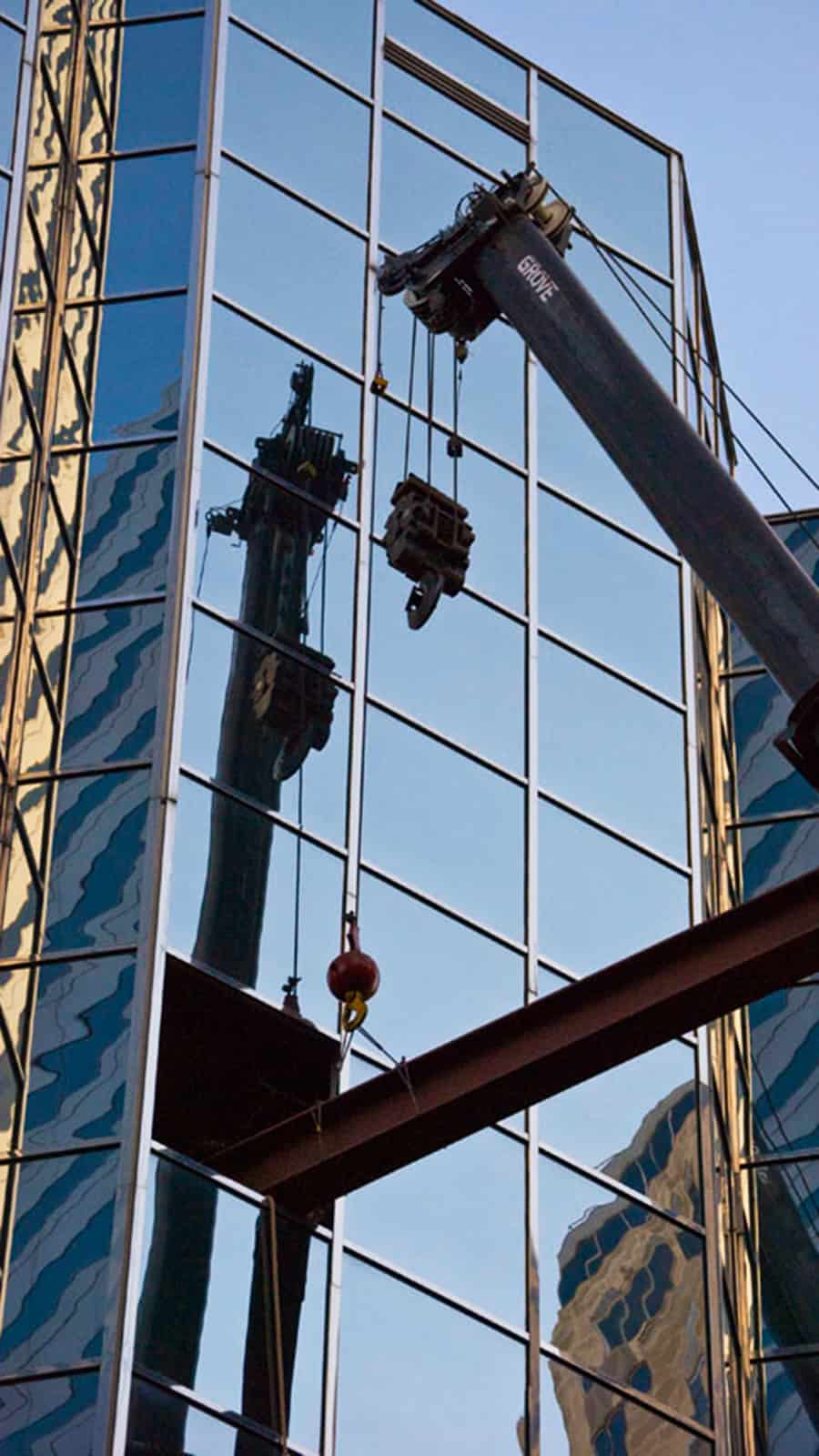 Photo of crane lifting beam into Leadership Square