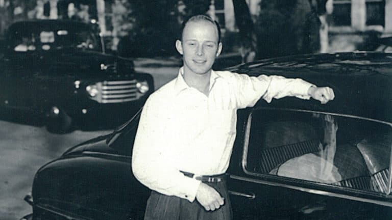 Photo of Reford Bond III in front of a car