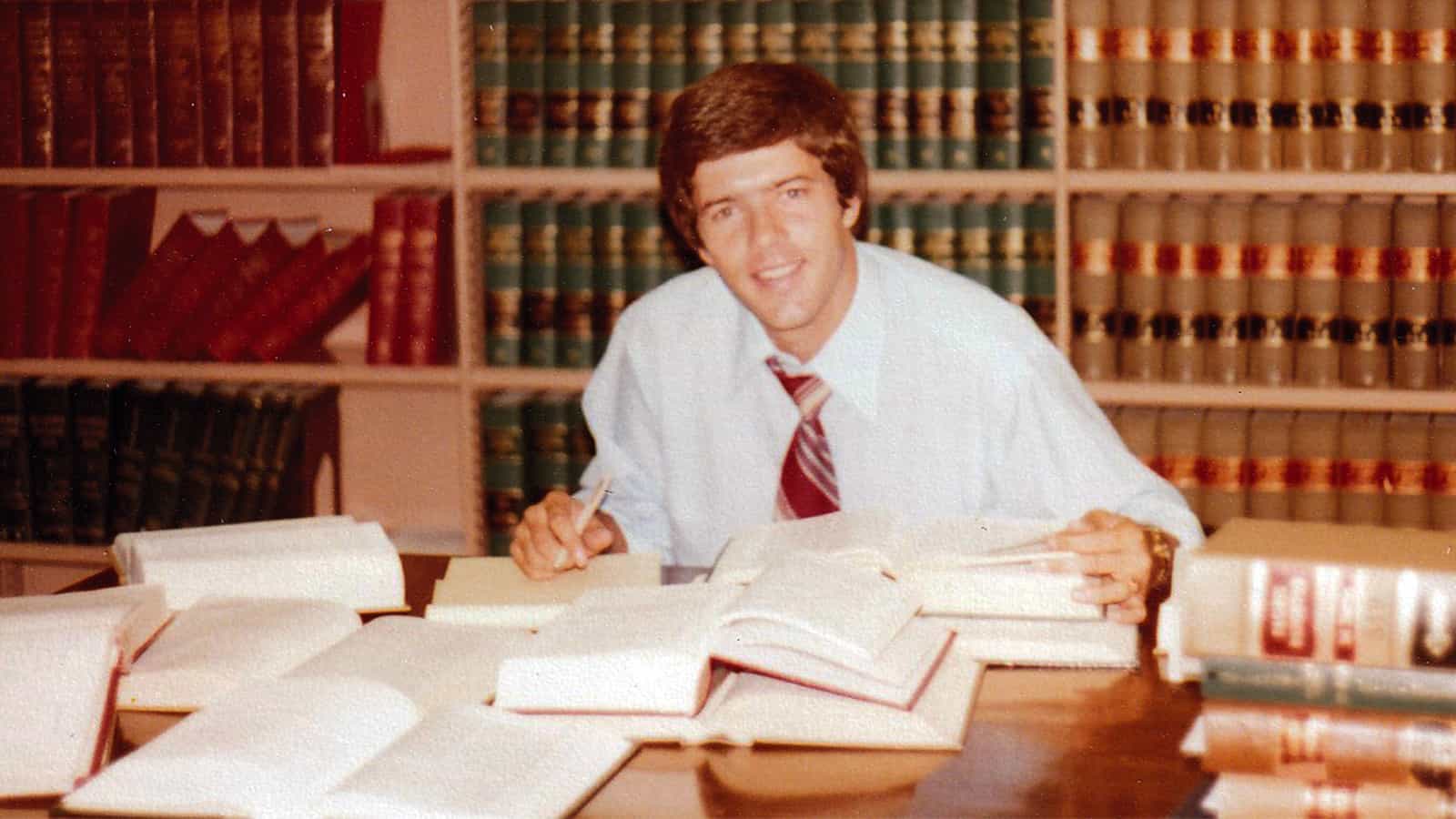 Photo of Mark Burget in the firm law library in 1980.