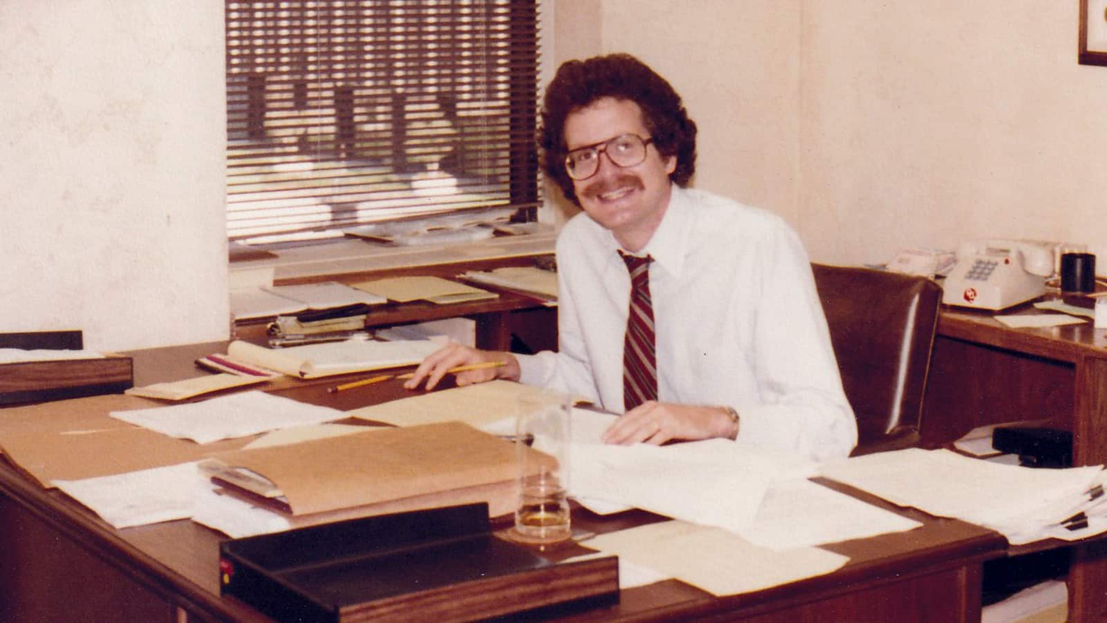 Photo of Louis Price in his firm office in 1980.