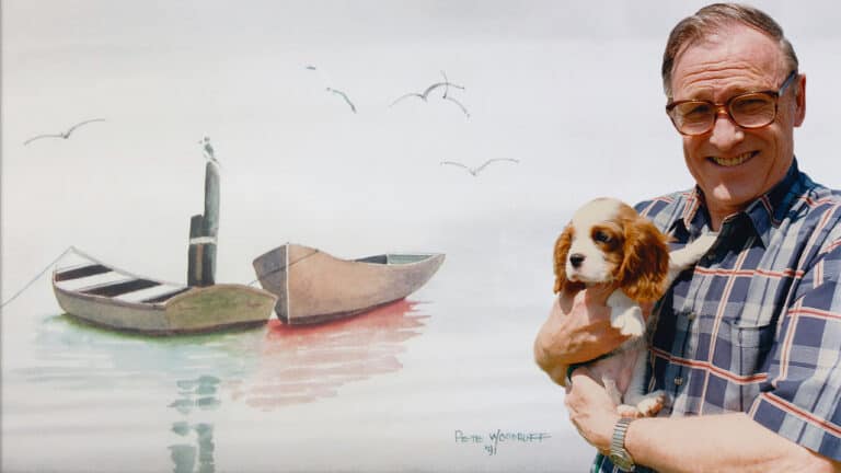 Graphic of Pete Woodruff holding a puppy in front of his painting